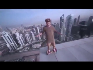 riding a hoverboard on the edge of a skyscraper roof